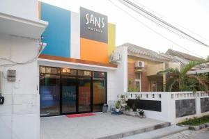 a building with a sign on the side of it at SANS Hotel City Park Semarang in Alastuwo