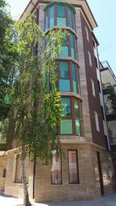 a tall building with a tree in front of it at Guest rooms Sveti Nikola in Pomorie