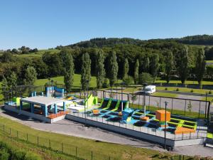 a playground in a park with colorful slides at Hotel Dolenjc in Novo Mesto