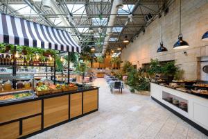 a food court with a counter with fruits and vegetables at Prima Park Hotel Jerusalem in Jerusalem