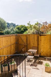 a patio with two chairs and a fence at New - Bright - Fresh - with Parking in Bath