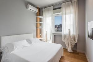 Posteľ alebo postele v izbe v ubytovaní Ferrini Home - Suites