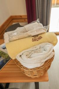 a basket of towels sitting on a table at Hotel Lärchenhof in Ramsau am Dachstein