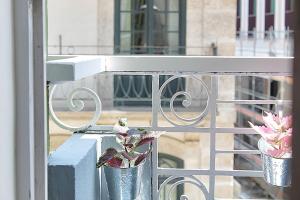 a white railing with two potted plants on a balcony at Oporto Sweet Downtown 5 in Porto