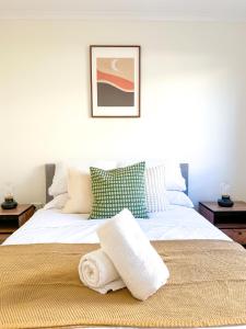 a bedroom with a bed with a towel on it at Convenient 2BR in Marrickville in Sydney
