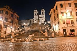 a set of stairs in a city at night at Roma Resort Colosseum in Rome