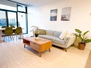 a living room with a couch and a table at Convenient 2BR in Marrickville in Sydney