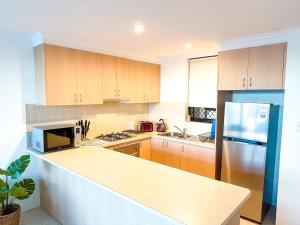a kitchen with a counter top and a refrigerator at Convenient 2BR in Marrickville in Sydney