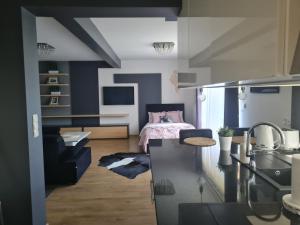 a kitchen and living room with a bed in the background at U Tatarów in Suche