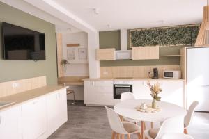 a kitchen and dining room with a table and chairs at Bantle Pension Gästehaus Ravensburg in Ravensburg