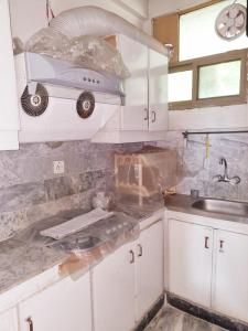 a kitchen with a sink and a car on the wall at Bird's Nest in Bhurban