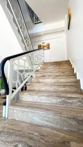 a staircase in a building with a metal railing at Casa Micle - Free Private Parking in Craiova +32 photos