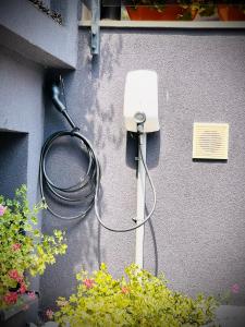 a house with a power cord plugged into a wall at Casa Micle in Craiova
