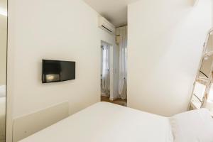 Televízia a/alebo spoločenská miestnosť v ubytovaní Ferrini Home - Suites