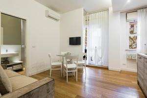 a living room with a couch and a table at Ferrini Home - Suites in Catania