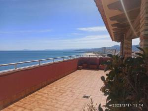 a balcony of a building with a view of the ocean at Espectacular terraza y vistas en 1a línea de playa in Cullera