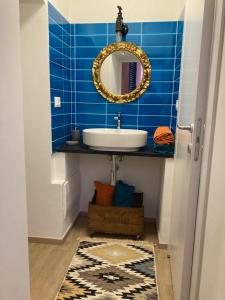 a bathroom with a sink and a mirror at La casa di Toni 2 passi dal mare in Finale Ligure +12 photos