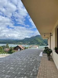 an empty patio with a view of the water at Silver Mountain Villa Colibita in Colibiţa