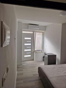 a room with a bed and a window and a door at Ada in Zadar