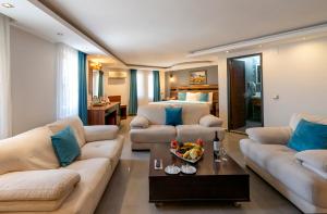 a living room with two couches and a bed at SIGNATURE GARDEN AVANOS Hotel & SPA in Avanos