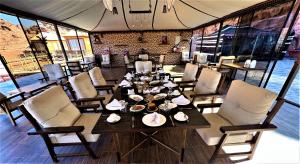 - une salle à manger avec une table et des chaises dans l'établissement The Villas - Bedouin Boutique Resort, à Wadi Rum