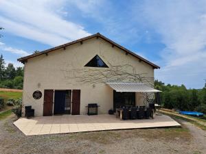 a large white building with a large window on it at "Le petit bonheur" Gîte van 4 tot 12 personen met privé vijver van 2Ha in Maisonnais-sur-Tardoire