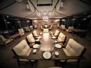a large dining room with a long table and chairs at The Villas - Bedouin Boutique Resort in Wadi Rum