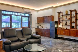 a living room with a couch and a refrigerator at Kyara Villa Apartments in Canggu