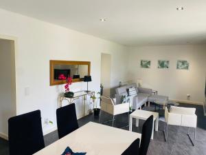 a dining room with white tables and white chairs at Serra de Arga Mountain House in Montaria