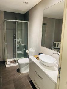 a bathroom with a sink and a toilet and a shower at Serra de Arga Mountain House in Montaria +51 photos