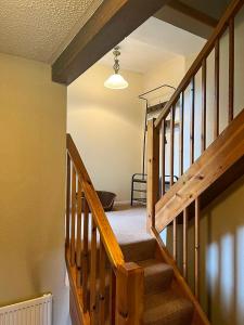 a wooden staircase in a house with a light at Windale at Wetheral Cottages in Great Salkeld