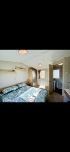 a bedroom with a large bed in a room at Tarka Holiday Park in Ashford