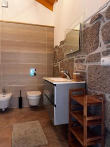 W łazience znajduje się umywalka, toaleta i lustro. w obiekcie Pilgrims Rest - Vila Nova de Cerveira - Hostel - Albergue - AL w mieście Vila Nova de Cerveira