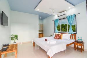 a bedroom with a large bed and a window at SK Holiday Homes in Alibaug