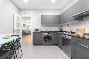 a kitchen with a washer and dryer in it at House Riberas in Loyola