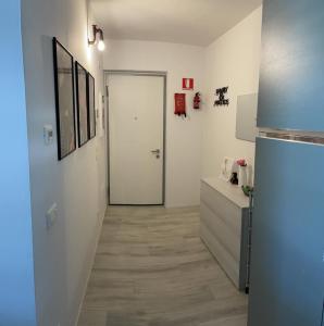 a kitchen with a refrigerator and a hallway at Green Life in Riva del Garda