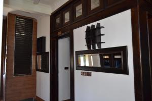a room with a door and a mirror on the wall at BW Residence in Kalmunai