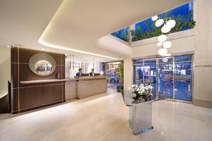 a lobby of a building with a reception desk and flowers at Bentley Hotel Bosphorus - Special Class in Istanbul