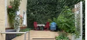 a patio with two red chairs and a table at Donatsgasse18 in Freiberg