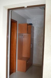 a mirror in a room with a closet and a refrigerator at Apartment Nadja in Zlatibor