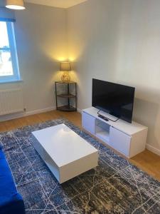 a living room with a flat screen tv and a couch at Colchester Smart Two Bed Apartment in Colchester