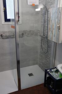 a shower with a glass door in a bathroom at Maison de vacances au bord de la plage in Trégunc +29 photos