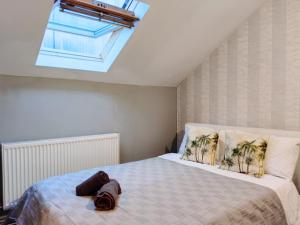 a bedroom with a large bed with a skylight at Bee Stays - Crossbar Hotel One-Bedroom Flats in Warrington