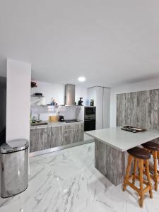 a kitchen with white marble floors and a white counter top at Luxury Oceanfront Amazing view Playa del Acequion in Torrevieja