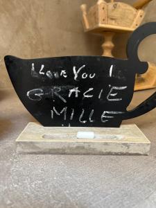 a black cup with the words leave you a little wiser at Nellali in Gressan