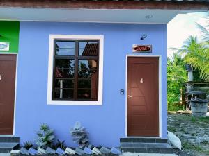 a blue house with a door and a window at The Marak Village KB - Mini Homestay in Kota Bharu