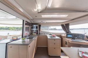 a kitchen in a boat with a large window at LUXE Crewed Catamaran, Sailing Mangofloat, Croatia in Split