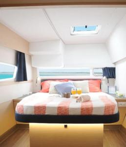 a bedroom with a bed in the middle of a boat at LUXE Crewed Catamaran, Sailing Mangofloat, Croatia in Split