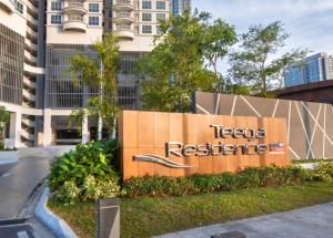 a sign in front of a building at Teega Modern 4BR 12pax pooltable by Our Stay in Nusajaya