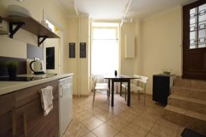 a kitchen with a table and a dining room at EcoStay Apartment by the Basilica in Budapest